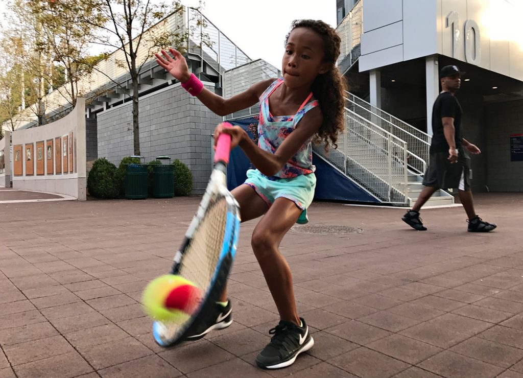 NEW YORK, NY - SEPTEMBER 10: A young tennis fan Ligaya Murray, 8, from Yonkers, NY plays with her family who are big tennison the grounds during Day Thirteen of the 2016 US Open at the USTA Billie Jean King National Tennis Center on September 10, 2016 in Queens. (Landon Nordeman for ESPN)
